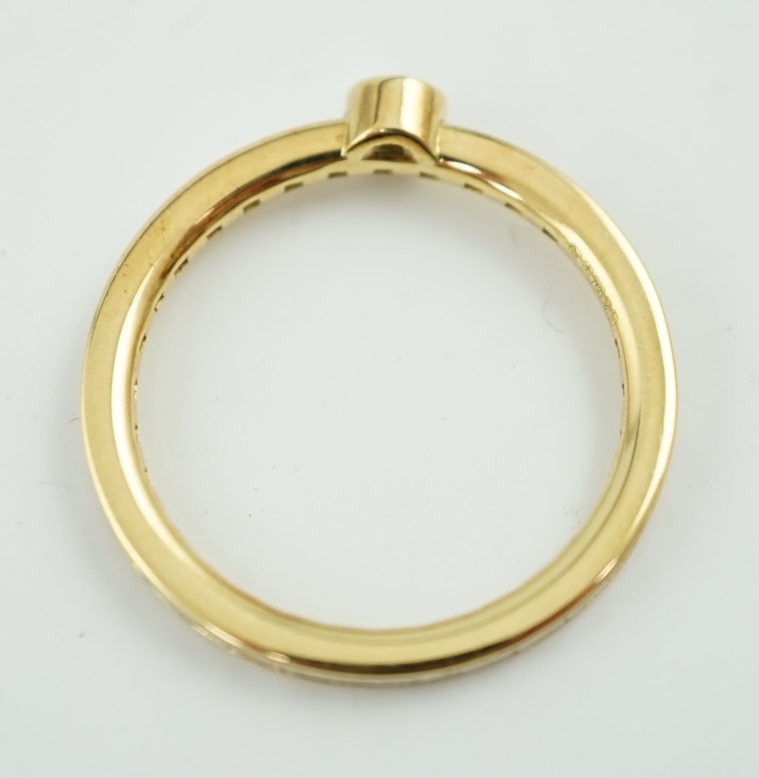 A modern 18ct gold, round and baguette cut diamond set ring